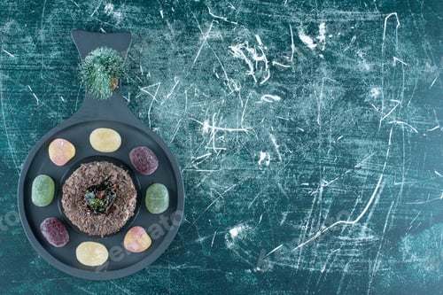 Preview: A dark board with chocolate cake with sweet marmalade
