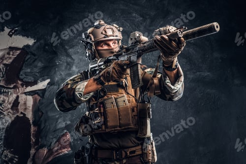 Preview: Special forces soldier in camouflage uniform holding an assault rifle with a laser sight