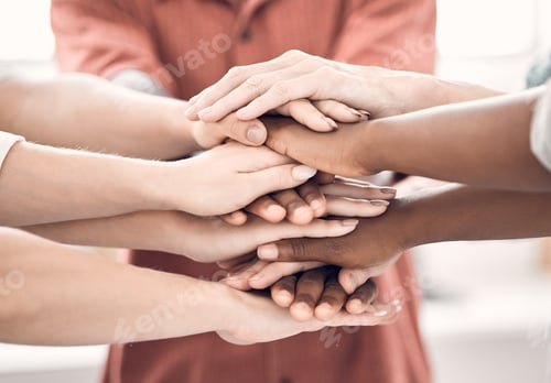 Preview: Group of diverse businesspeople piling their hands together in an office at work. Business professi