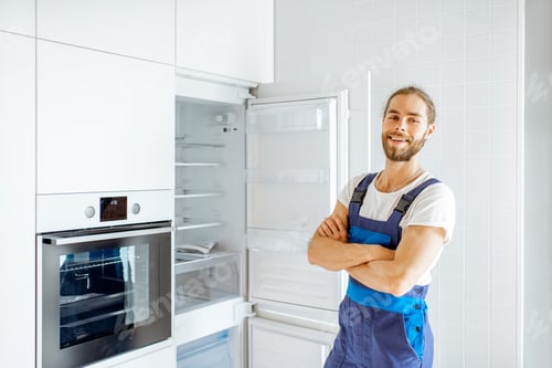 Preview: Workman installing fridge on the kitchen at home
