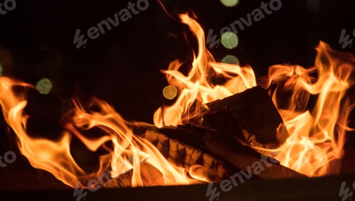 Preview: Fire in fireplace with colorful flames on black background. Close up with details, space.