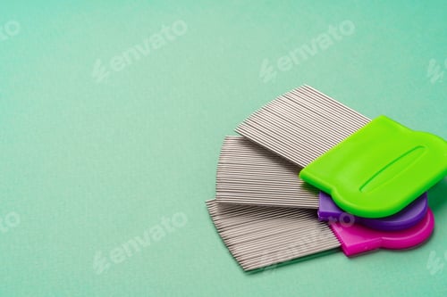 Three combs for lice removing on green background
