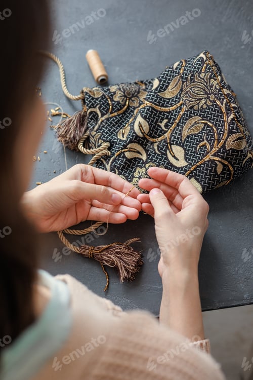 Preview: beadwork and embroidery of handmade gold beads and glass beads. women's hands make a bag