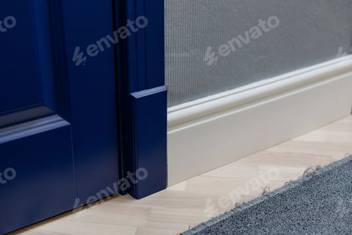 Preview: Blue wooden door and adjoining high classic floor plinth. Interior decor elements