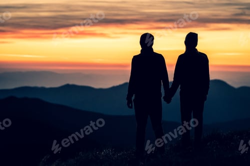 Preview: The silhouette of a couple on the mountain with a sunset background