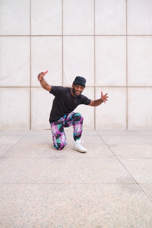 Preview: Young black male dancer showing hip hop moves outdoors