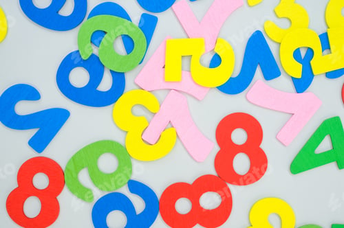 Preview: Top view of the colorful wooden numbers scattered on a bl surface