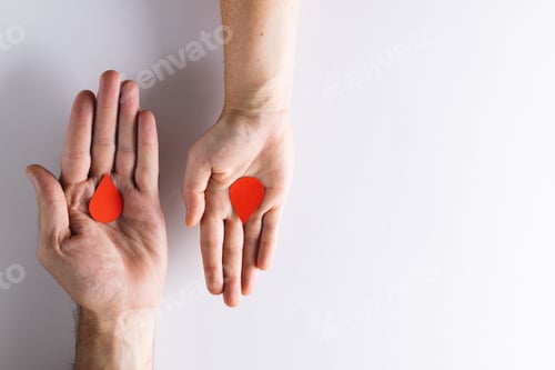 Preview: Hands of caucasian woman and man holding blood drops, on white background with copy space