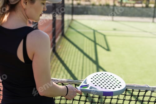 Preview: Woman padel tennis player training on court. Woman using racket to hit ball.