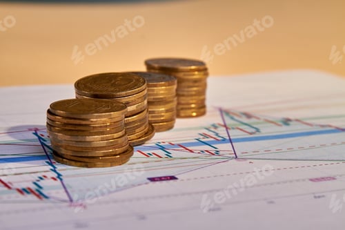 Preview: Gold Coins Stacked on a Financial Stock Chart