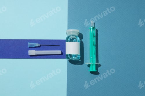 Preview: Glass medical bottle with vaccine and syringe on blue background, top view
