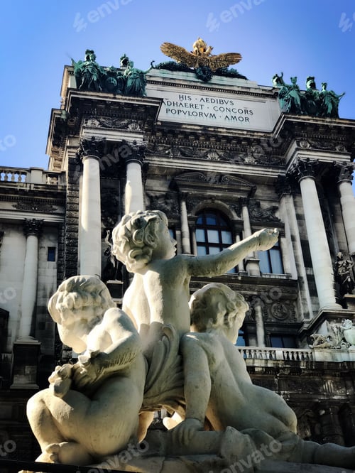 Preview: a statue sits in front of a large building with a clock on it