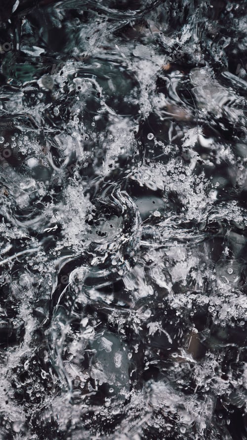 Preview: Abstract close-up of splashing water with bubbles and ripples.
