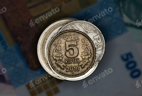 Preview: Closeup of Indian Rupee coin on a stack of a world coins