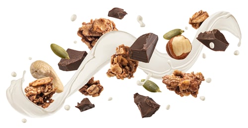 Preview: Falling granola with milk splash, nuts and chocolate pieces isolated on white background