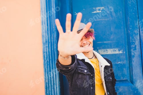 Preview: Cheerful teenager smile and put his hands