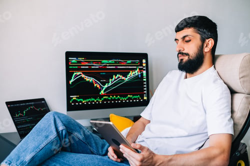 Preview: Caucasian businessman trading online, using computer technology, looking on stock exchange