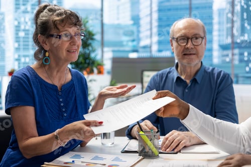 Preview: Financial advisor giving the retirement plan documents to old people