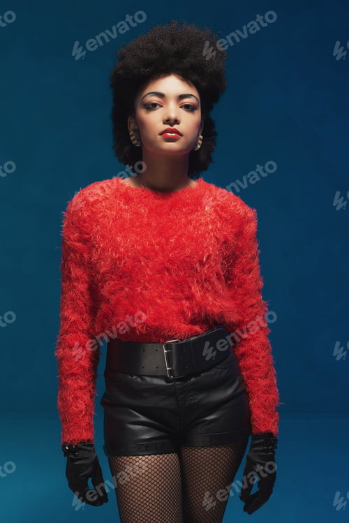 Preview: Three-Quarter Shot Of A Young Woman With Afro Hairstyle, Wearing Trendy Furry Red Shirt And Black