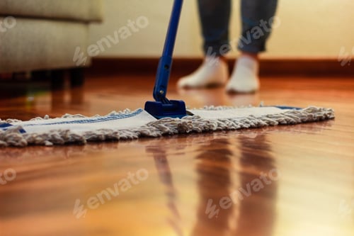 Preview: Unrecognizable woman cleaning the hardwood floor