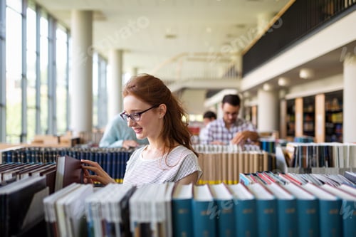 Preview: Happy group of success students studying and working together in a college library