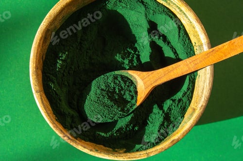 Preview: Blue-green algae Chlorella and spirulina powder in bamboo eco bowl. Super powder in spoon. Detox
