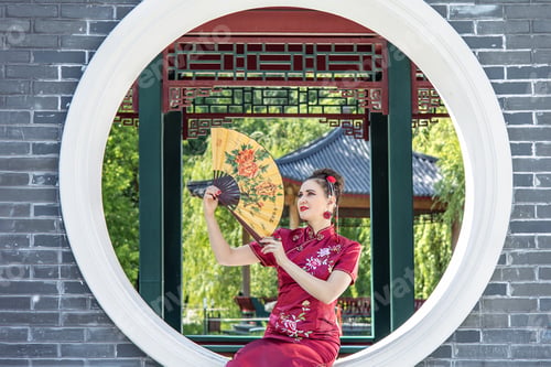 Preview: A Asian girl walks in national clothes with a fan in the park. Chinese woman in a red traditional