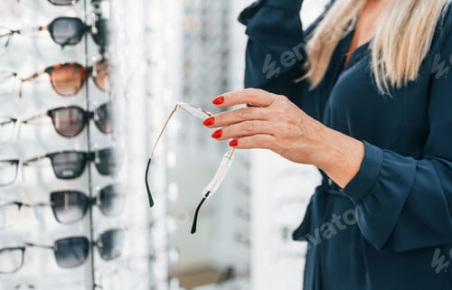Preview: Close up view of the woman that trying new glasses in the store