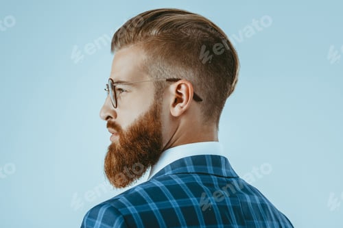 Preview: head and shoulders shot of man in eyeglasses with stylish hairstyle isolated on blue