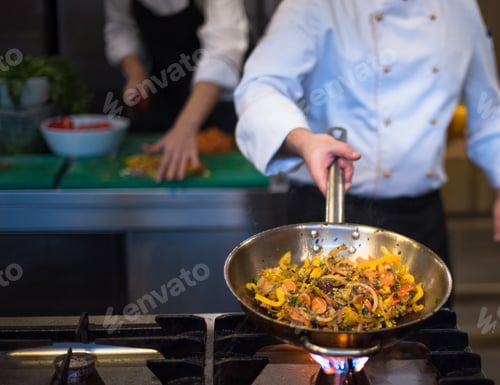 Preview: chef flipping vegetables in wok