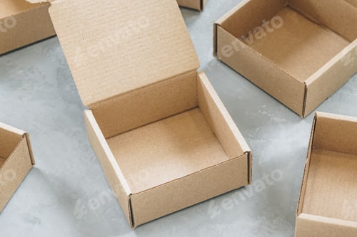 Preview: Paper Box close-up. Brown paper Box. Brown cardboard box on gray background, opened empty inside.