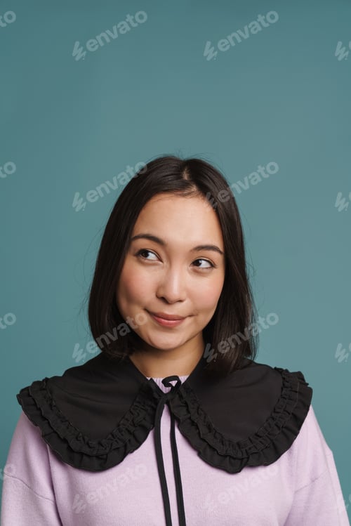 Preview: Young asian woman wearing collar smiling and looking aside