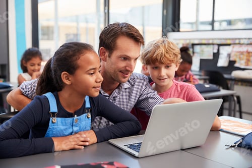 Preview: Teacher and two young students use laptop computer in class
