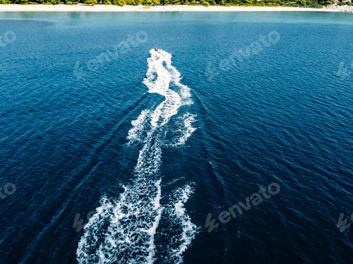 Preview: Aerial view of jet skier in blue sea. Jet ski in turquoise clear water racing