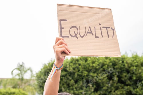 Preview: Poster with the word equality held by a woman's arm. LGBT concept.