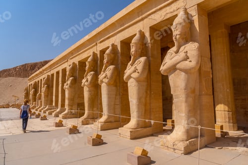 Preview: A young woman with pharaoh sculptures entering Hatshepsut's Funerary Temple in Luxor. Egypt