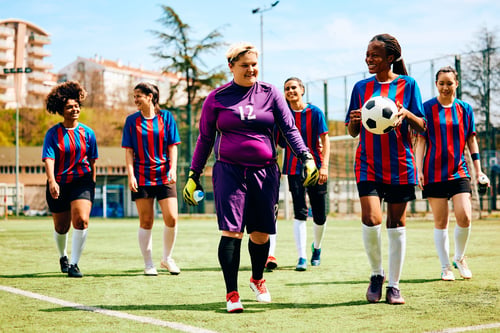 Preview: Happy women's soccer team leaving the stadium after the match.