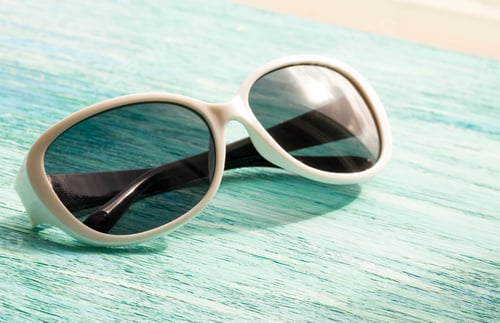 Preview: Stylish white sunglasses on the wooden background close up. horizontal summer