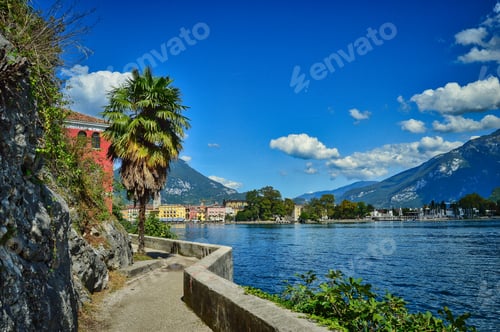 Preview: landscape of Riva del Garda, Italy- garda lake with mountains, peaks, town, palm, beach, path, wall