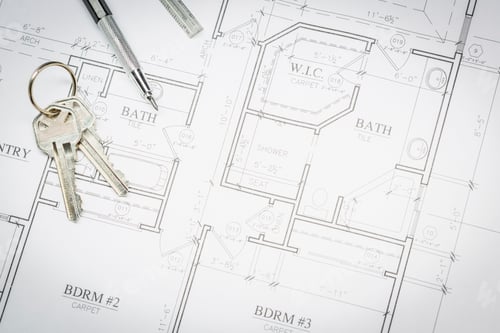 Preview: Engineer Pencil, Ruler and Keys Resting On House Plans
