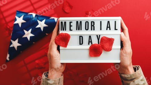 Preview: Holding memorial day sign on red background