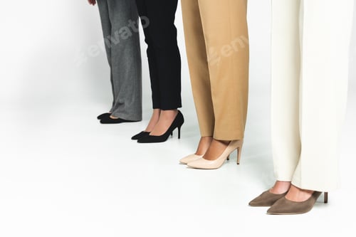 Preview: cropped view of multicultural businesswoman standing on white