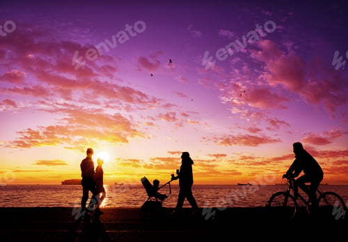 Preview: Silhouettes of people enjoying a walk by the seaside