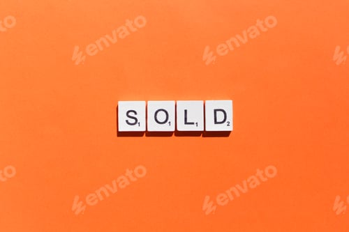 Preview: Sold scrabble letters word on a orange background