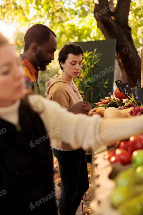 Preview: Smiling female client enjoying farm shopping experience at local food farm market