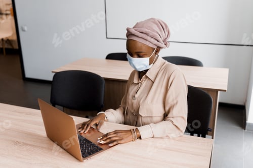 Preview: Focused Woman Working on Laptop in Office