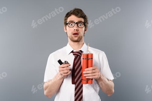 Preview: shocked businessman holding lighter and dynamite on grey background