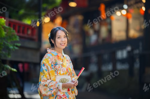Preview: Asian woman try to wear Japanese kimono with the traditional Japanese village background