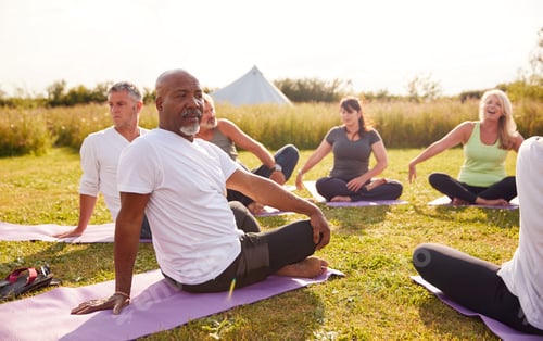 Preview: Adults Practicing Gentle Yoga in a Grassy Field