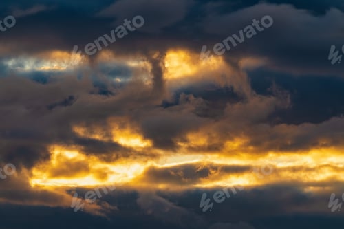 Preview: Beautiful dramatic clouds in sky illuminated by rays of sun at sunset to change weather. Colorful